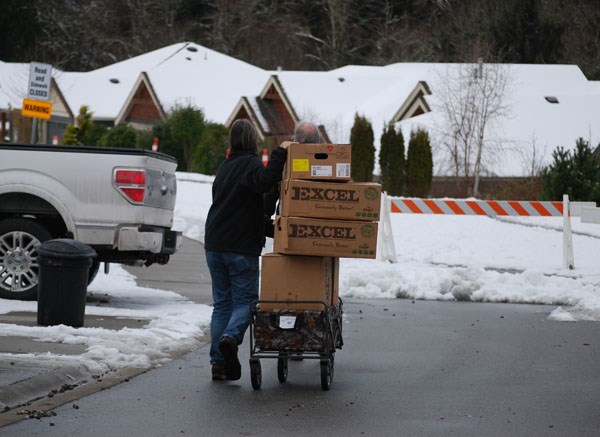 A Seawatch resident carts boxes to his home, which is now on evacuation alert due to sinkhole activity. Many in the neighbourhood spent Friday packing to be ready for an evacuation order that could come next week.