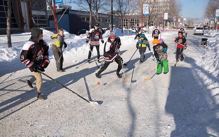 Kids play street hockey with members of the North Central Bobcats bantam team on Sunday afternoon at Canada Games Plaza as part of 2019 Downtown Winterfest.