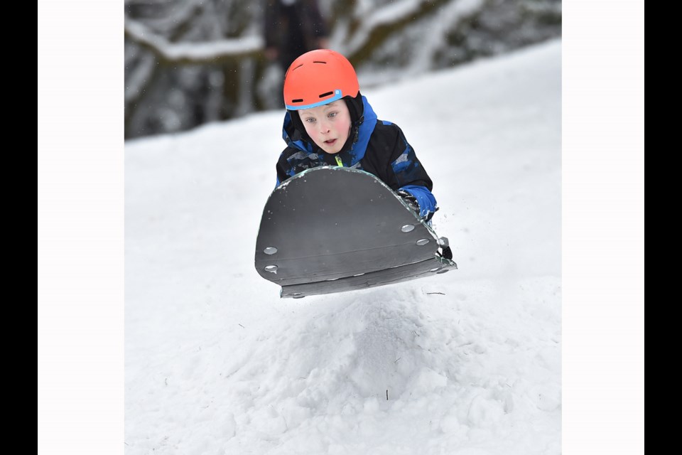 Nine year old Cameron McRae takes a jump on his sled at Queen Elizabeth park Tuesday morning. Photo Dan Toulgoet