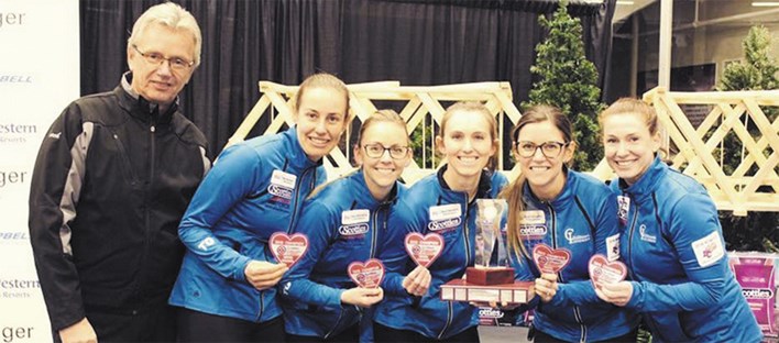 Team Wark, including coach Rick Fewster, left, Jen Rusnell, third from left, and Kristen Pilote, fifth from left, poses with the B.C. championship trophy on Feb. 3 in Quesnel. – Team Wark Facebook photo