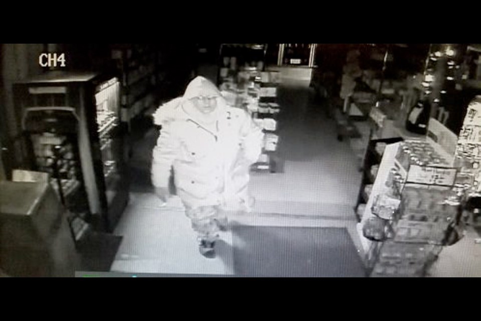 Surveillance video shows a suspect in a break-in and ATM theft on Feb. 9 at a Happy Valley Road convenience store.