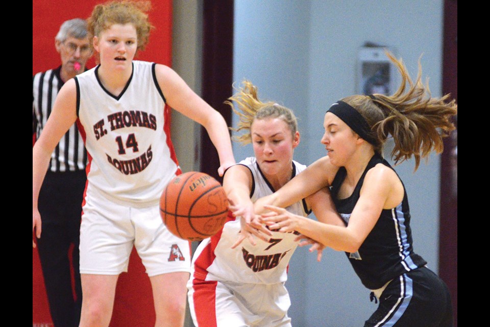 STA’s Jessica Clarke and Olivia Thorpe scrap with Seycove’s Chelsea Bradshaw during the North Shore senior girls AA final Feb. 6. photos Paul McGrath, North Shore News