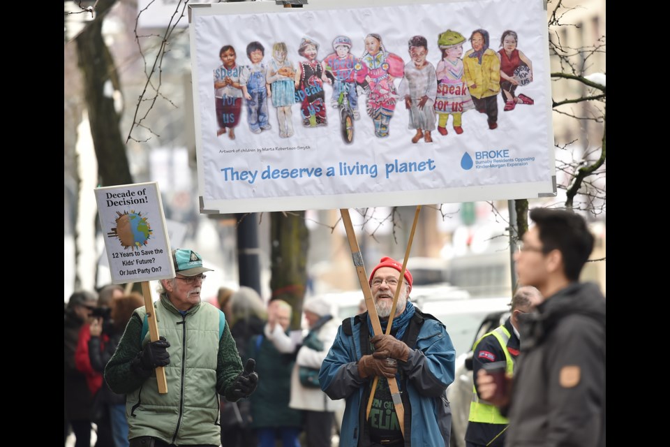 Karl Perrin of BROKE protests outside National Energy Board's Vancouver office.