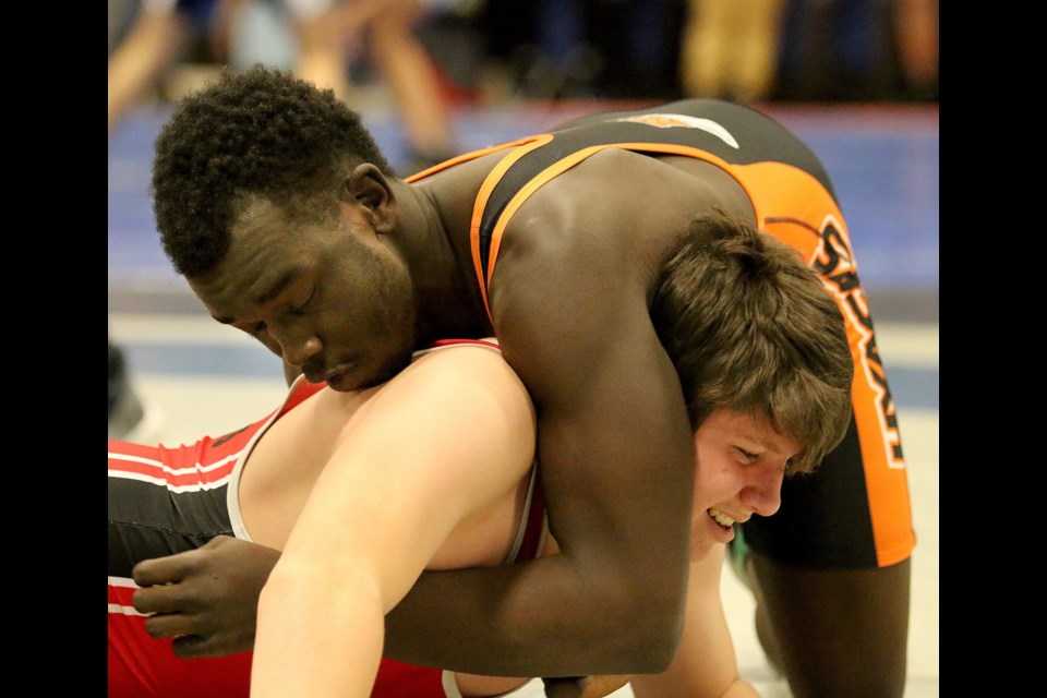 New Westminster’s Titgol Jok, top, gets St. Thomas More’s Luke Perizzolo in a hold in their 84-kilogram clash at last week’s Lower Fraser Valley meet in Port Moody. Jok won the final, with Perizzolo taking silver.