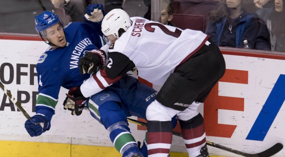 Luke Schenn hits Michael Del Zotto along the boards.