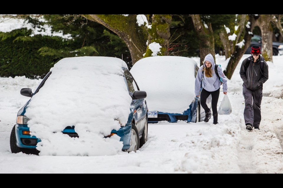 Cars were covered in snow on Torquay Drive as Lambrick Park Secondary students Teagan Hunt, 15, and Fraser Smith, 17, walked home from school during the capital's brief scrape with winter.