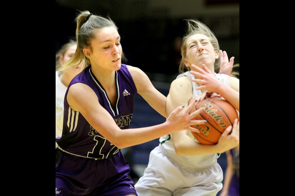 MARIO BARTEL/THE TRI-CITY NEWS Alanya Davignon, of the Riverside Rapids, battles Royal Bay's Hannah Cormode, for possession of the ball in the first half of their opening round game at the BC senior girls provincial AAA basketball championship, Wednesday at the Langley Events Centre. Riverside won the game, 108-49. Jessica Parker scored 31 points and Sammy Shields netted 29 to lead the Rapids.