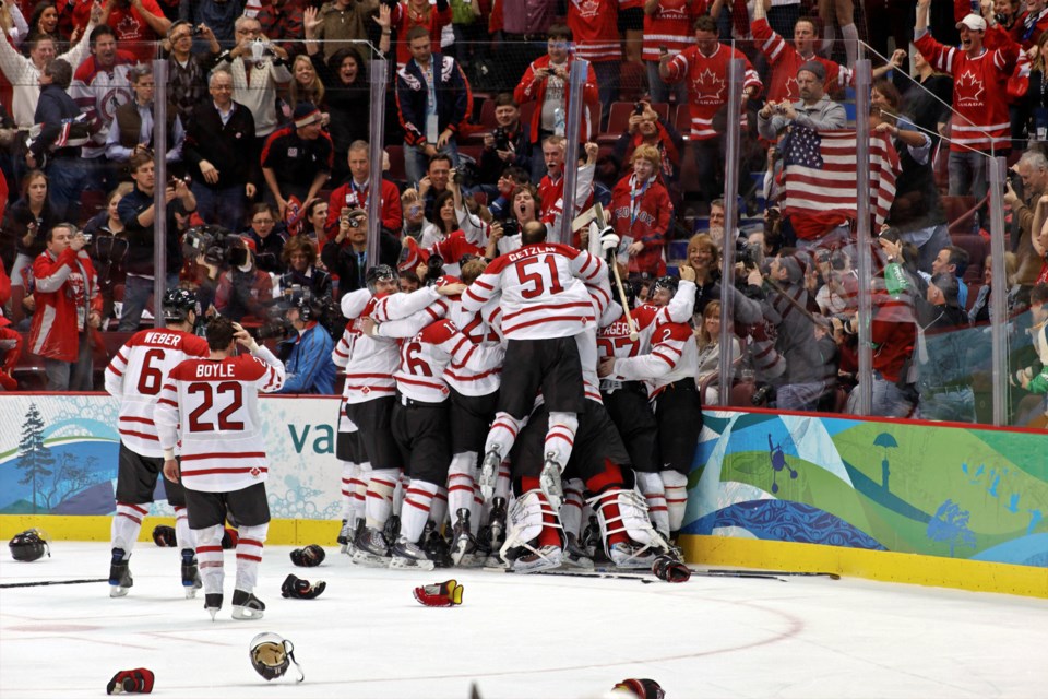 Team Canada players storm the ice at Rogers Arena on Feb. 28, 2010 after Sidney Crosby scored the game-winning goal in the gold medal contest.