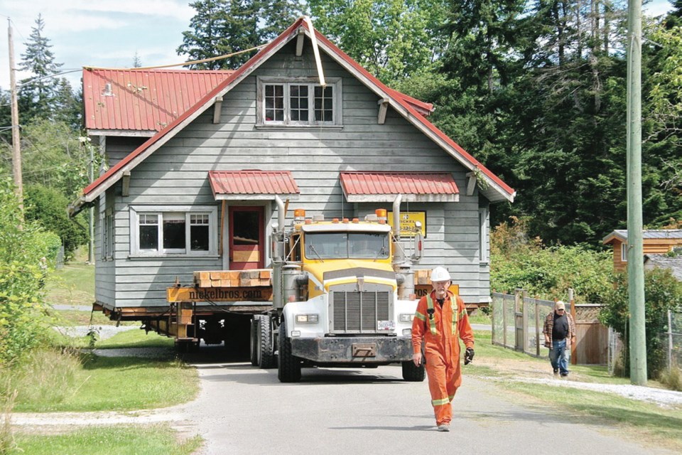 This house was moved from south Vancouver Island to Texada Island, near Powell River, by road, above, and barge, below.