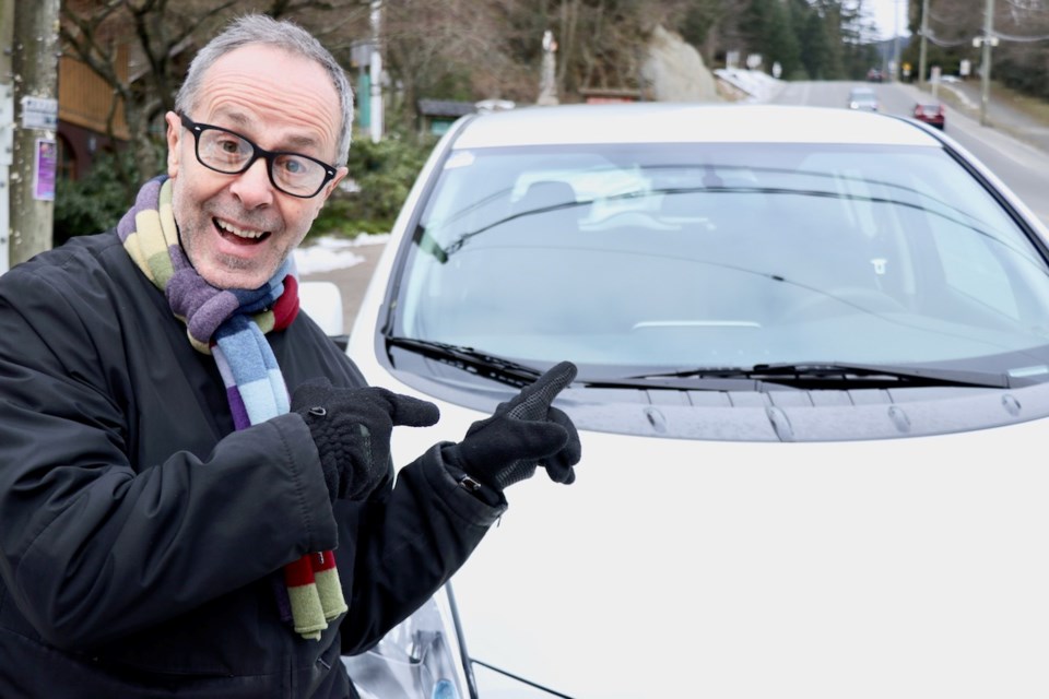 Anton van Walraven poses with his new, electric, car.