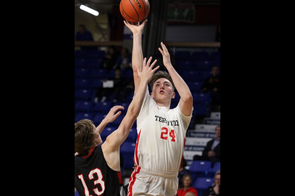 MARIO BARTEL/THE TRI-CITY NEWS
Terry Fox Ravens' Grady Stanyer goes up for a shot over Mt. Baker's Jeff Lalach in the second half of their opening round game at the BC High School senior boys AAAA basketball championships, Wednesday at the Langley Events Centre.