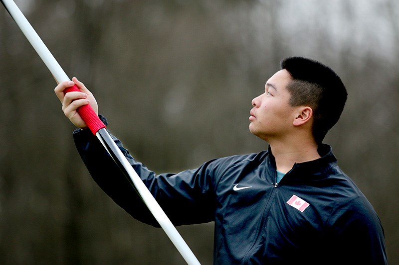 Jarrett Chong plucks his javelin out of the ground as he prepares to go through the steps he takes to throw it.