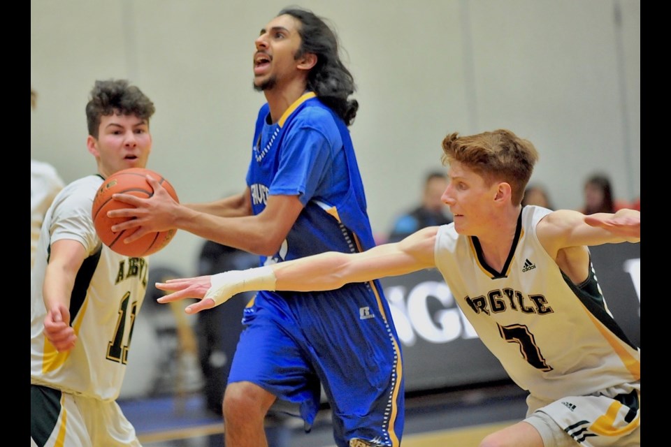 Usman Tung splits a pair of Argyle defenders for two of his 30 points in MacNeill's 77-68 quarter-final win at the BC AAA Boys Basketball Championships on Thursday at the Langley Events Centre.