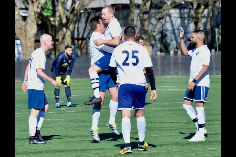Graduates celebrate one of their goals in a 4-0 win over West Coast FC in last Sunday's RASA Don Taylor League Cup final.