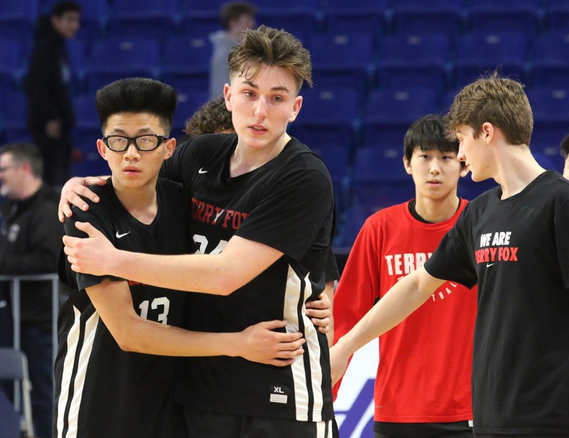 MARIO BARTEL/THE TRI-CITY NEWS
Terry Fox Ravens Grady Stanyer and David Chien console each other after their 74-67 loss to the Kelowna Owls in Saturday's second semi-final game.