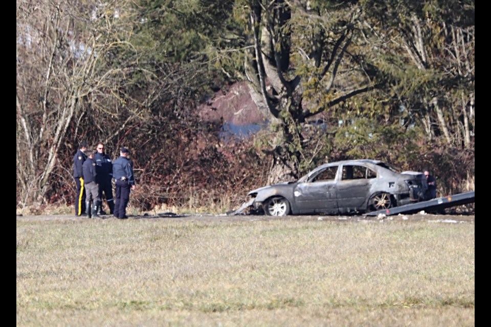 A burned out vehicle, possibly connected to a Tuesday morning shooting on Mitchell Island, is loaded onto a towtruck near No. 7 Road and Westminster Highway. Shane MacKichan photo