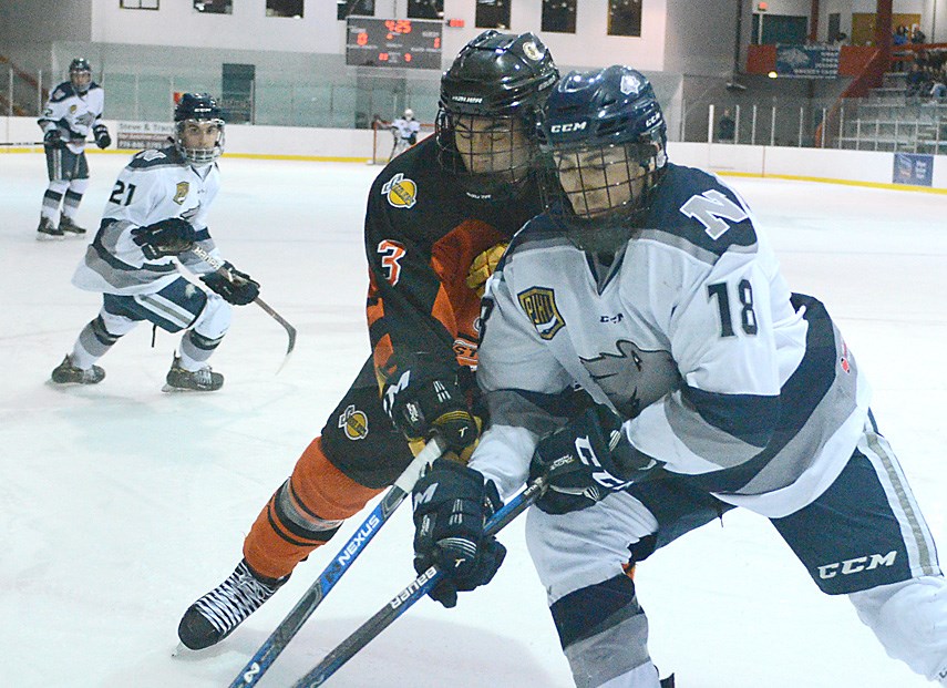 Aidan Bar-Lev-Wise of the North Van Wolf Pack jousts with a defender in PJHL playoff action. photo Paul McGrath, North Shore News