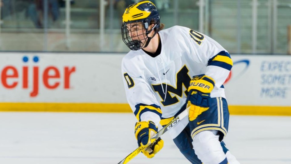 Will Lockwood skates the puck up ice for the University of Michigan Wolverines.