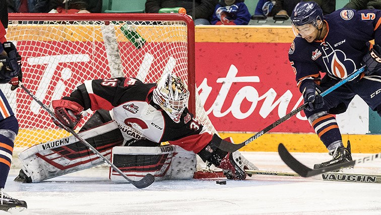 Kamloops Blazers defenceman Montana Onyebuchi tries to get to a loose puck in the Prince George Cougars' crease before golaie Taylor Gauthier can smother it. The Blazers beat Prince George 4-2 in the Cats' last game of the season in front of 5,178 spectators Saturday at CN Centre.