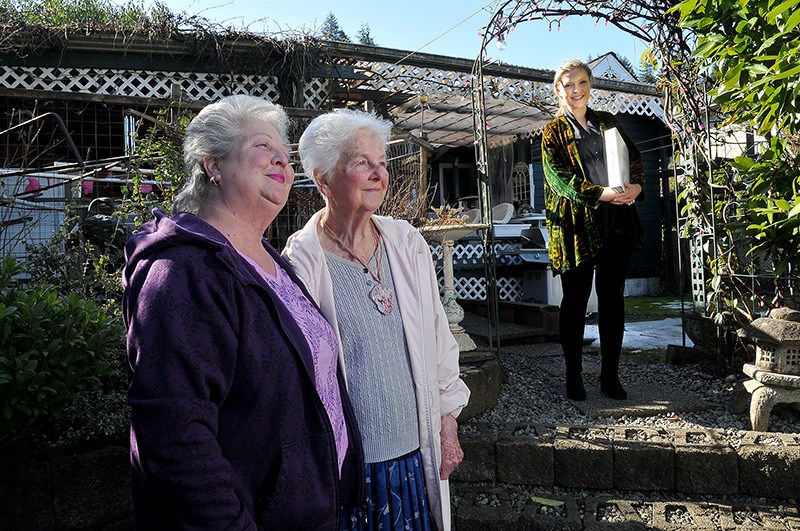 Allison Summer and her mother, Valerie Julian, enjoy the morning sunshine from where the deck will be located at the laneway home the family is building for Julian behind their own Henry Street home. Carola Alder, of CityState Consulting, helped design the home and navigate it through Port Moody's approval process that included an emotional appeal for a development variance permit which was approved by council on March 12.