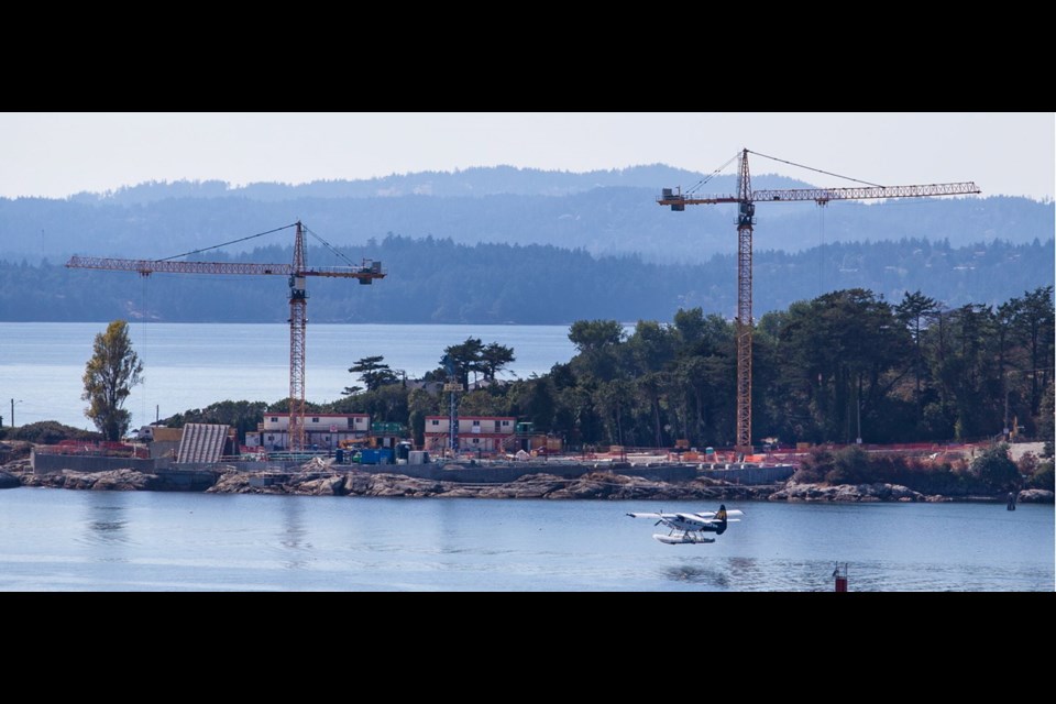 A seaplane flies past the wastewater treatment plant construction site at McLoughlin Point, a key part of the Capital Regional District's sewage-treatment mega-project.