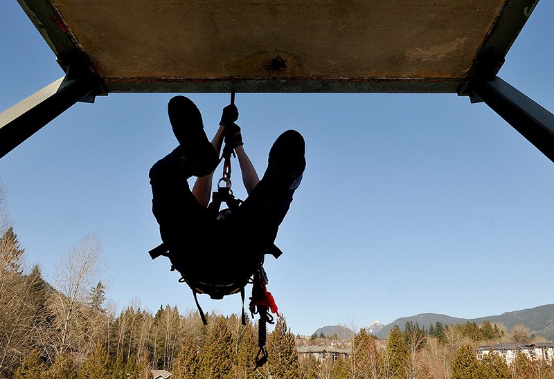 MARIO BARTEL/THE TRI-CITY NEWS Zach Hamed, a 17-year-old student at Heritage Woods secondary school, begins his descent from the training tower.