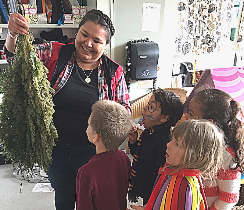 Students admire a hemlock bough covered in herring roe.