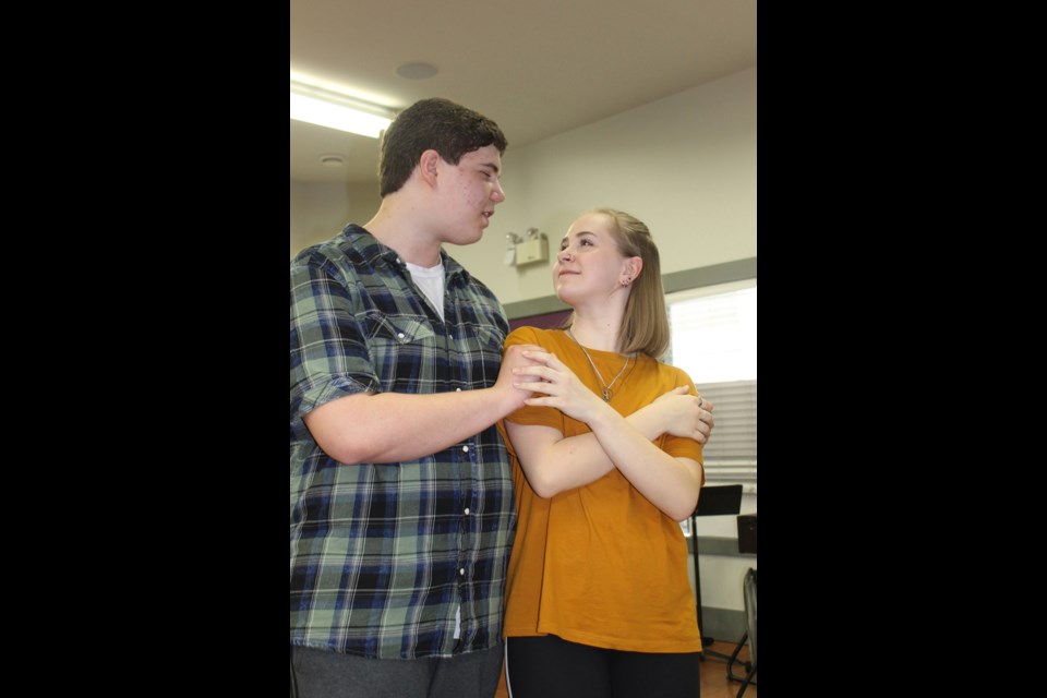 Lindbjerg Academy advanced music theatre student performers Avery Johnson, left, and Bailey Schmidt prepare for one of the final scenes of their production of Titanic the Musical, running April 12 to 14 at Shadbolt Centre for the Arts.
