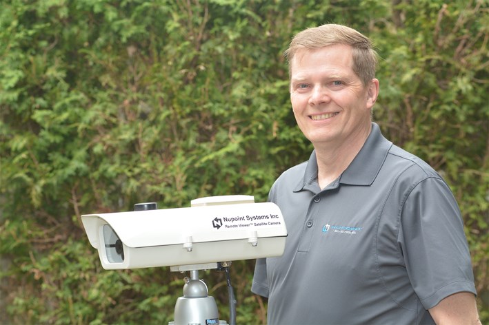 Delta's Nupoint Systems president Wayne Carlson with their unique satellite camera that monitors remote environments.