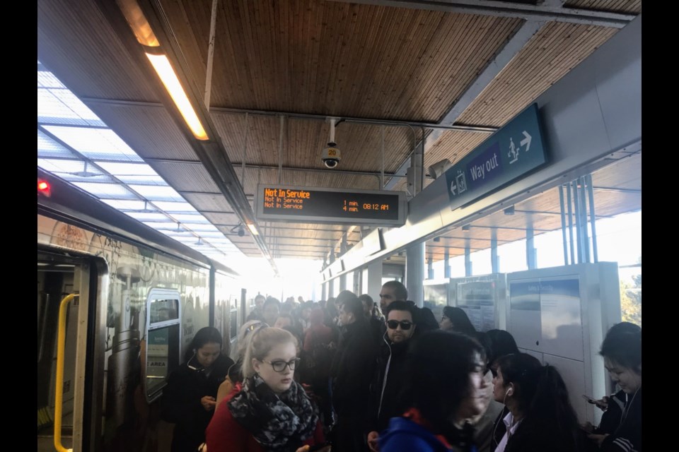 Passengers disembark at Marine Drive station after a train got stuck on the bridge crossing into Richmond and caused delays. Alyse Kotyk photo