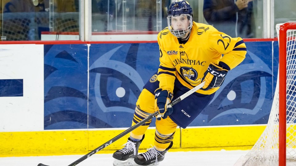 Brogan Rafferty skates the puck up ice for Quinnipiac University.