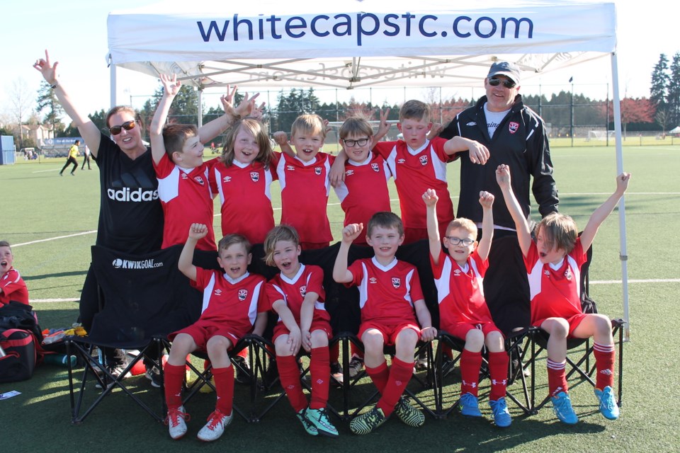 Deidre Farah (coach on far left) and Colin Turnbull (far right) with the Bowen FC U-9 boys team, the