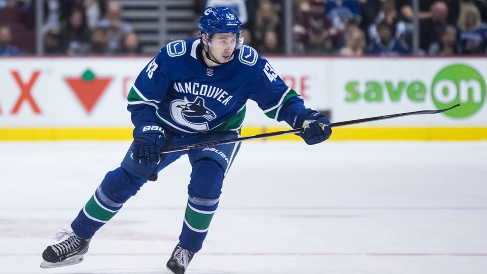 Quinn Hughes skates up ice for the Vancouver Canucks.