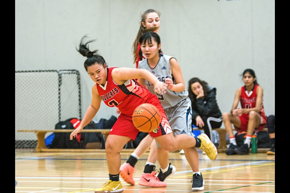 Burnaby Central's Jalynne Huynh, at left, holds off a defender during a game earlier this year. The Grade 12 guard was one of a select few chosen to play in Thursday's Senior Girls All-Star game at Riverside Secondary in PoCo.