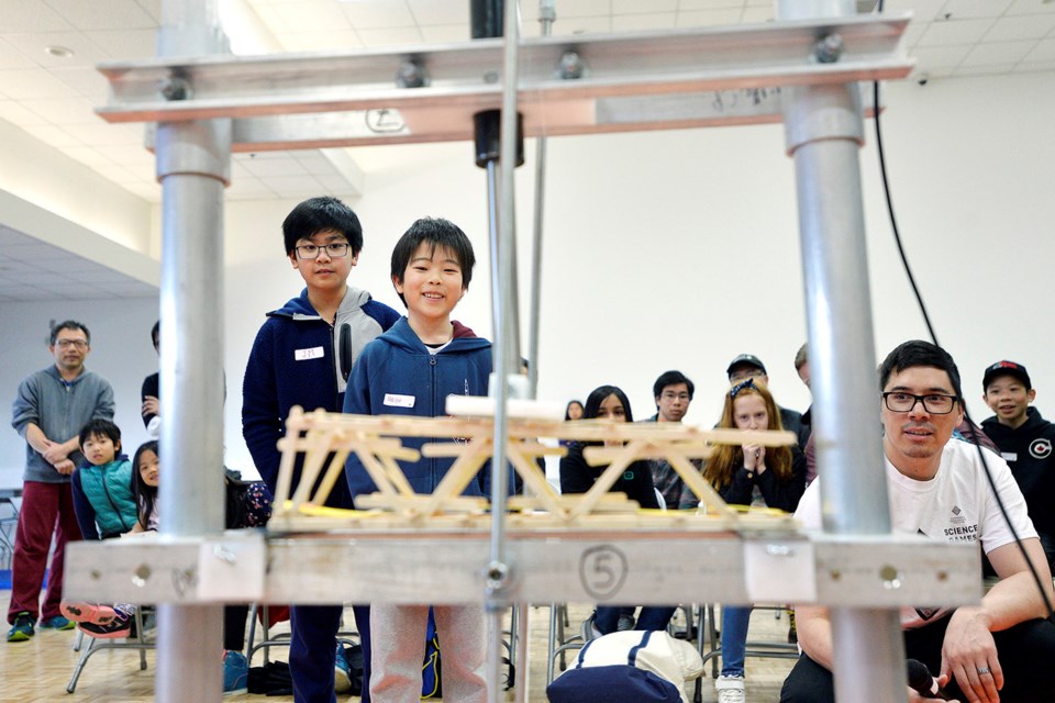 Eleven-year-olds Reiyo Hung and JM Venezuela watch as their bridge gets put to the test.