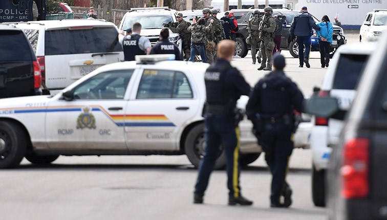 Residents left a building one-by-one on Wednesday when RCMP converged on the 2100 block of Tamarack Street in search of two men suspected of being involved in a shooting last week.