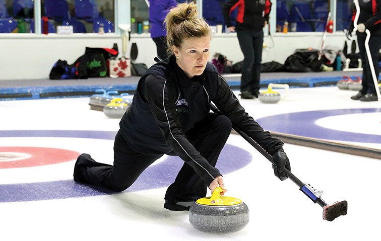 Tracey Jones prepares to let go a shot against Whitney Christy of Quesnel during their game Saturday at the Prince George women's bonspiel at Prince George Golf and Curling Club.