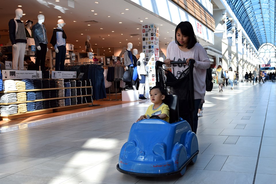 Jasmine Chan pushes her son at Richmond Centre. Photo: Megan Devlin/Richmond News