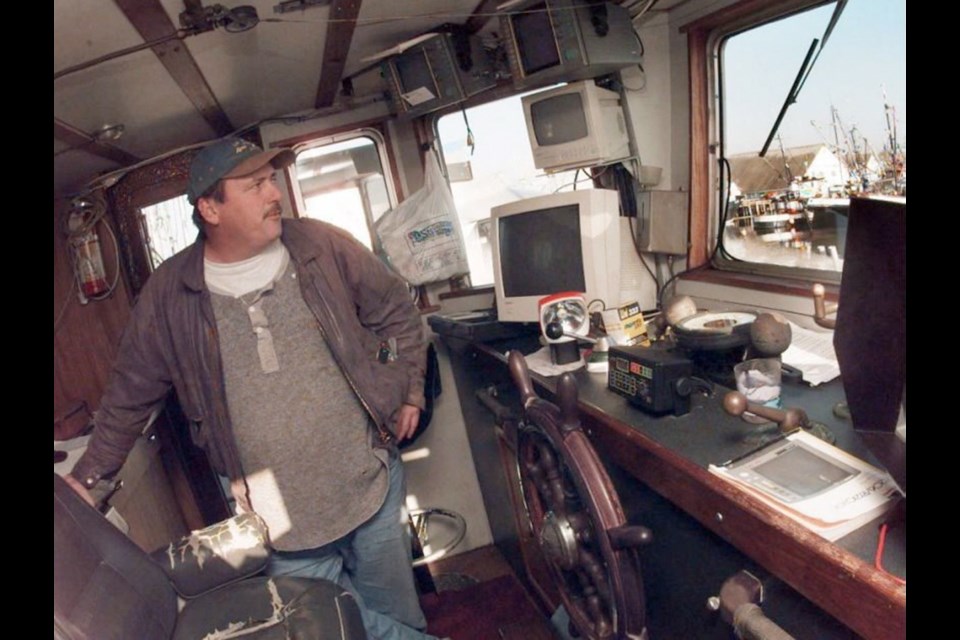 Skipper John (Phil) Stirling in the wheelhouse of the Western Wind fishing boat docked at Fisherman&Otilde;s Wharf in Steveston in 2000.
