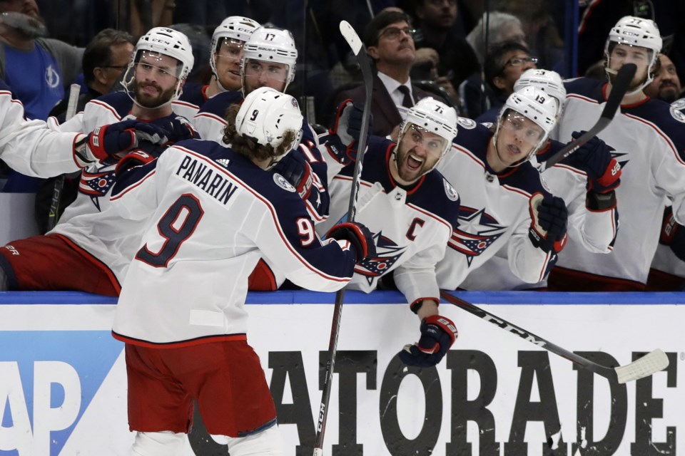 Artemi Panarin celebrates a goal with the Columbus Blue Jackets bench.