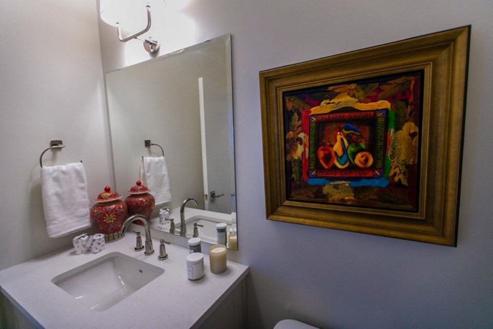 Updated powder room has a new vanity, all new fixtures, a new under-mounted sink and art by Grant Leier.