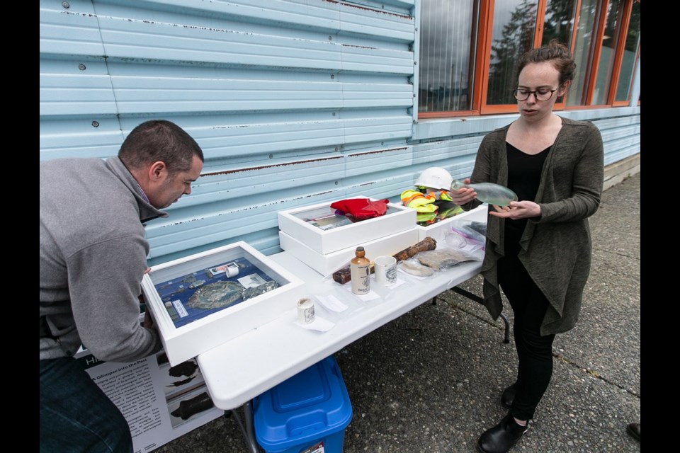 Mike Bodman and Caitlin Craig with artifacts dredged from Victoria Harbour. April 2019