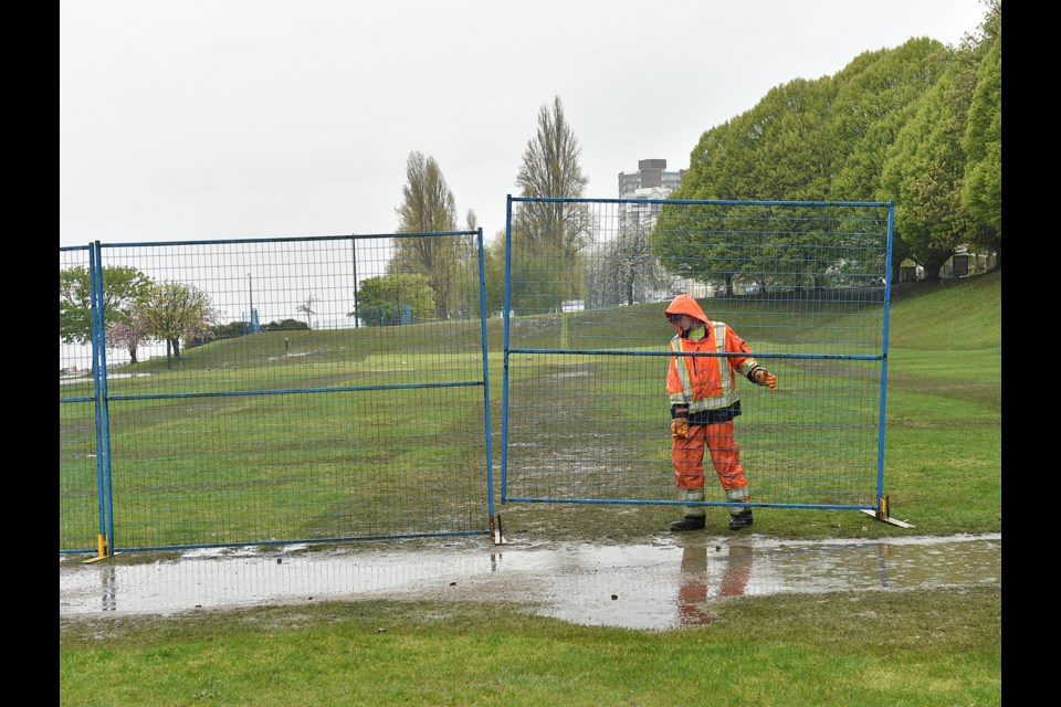 Crews put up fencing around the field at Sunset Beach Park April 22. Photo Dan Toulgoet