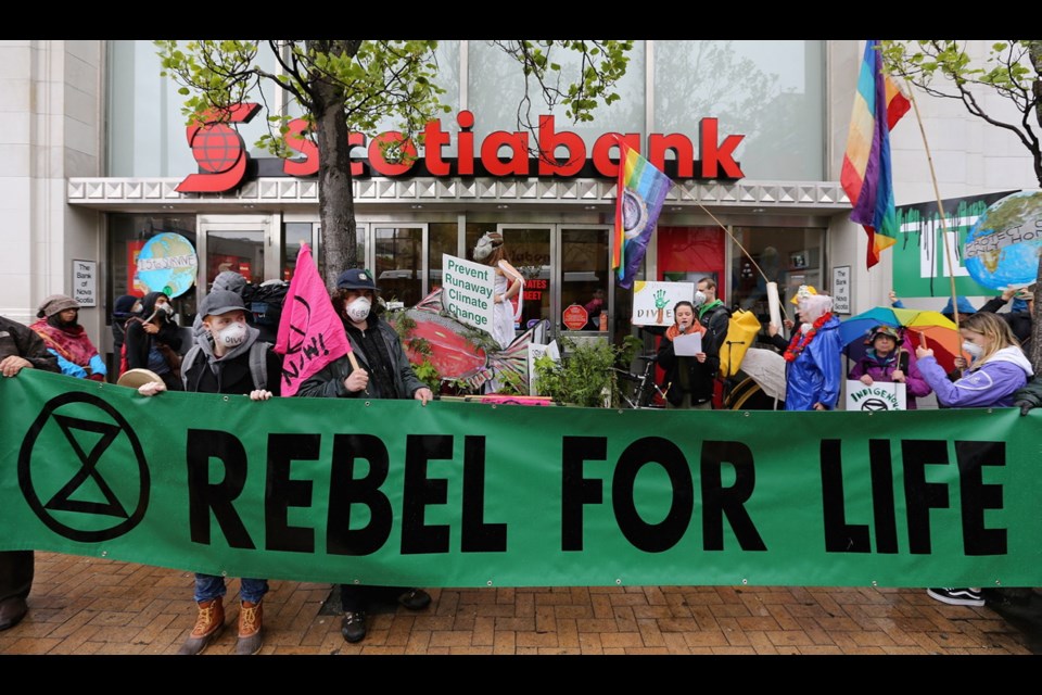Demonstrators stopped at the Bank of Nova Scotia, 702 Yates St., where organizer Antonia Paquin of the group Extinction Rebellion Vancouver Island read a statement from Mother Earth.