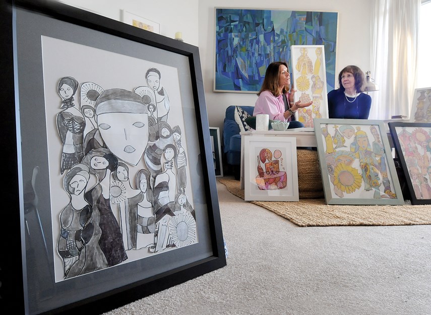 Sisters Shelley Adams and Clare Hetherington sit surrounded by some of their mother Bernice Hetherington’s artwork which is on its way to the Vancouver Convention Centre for Art Vancouver April 25-28.