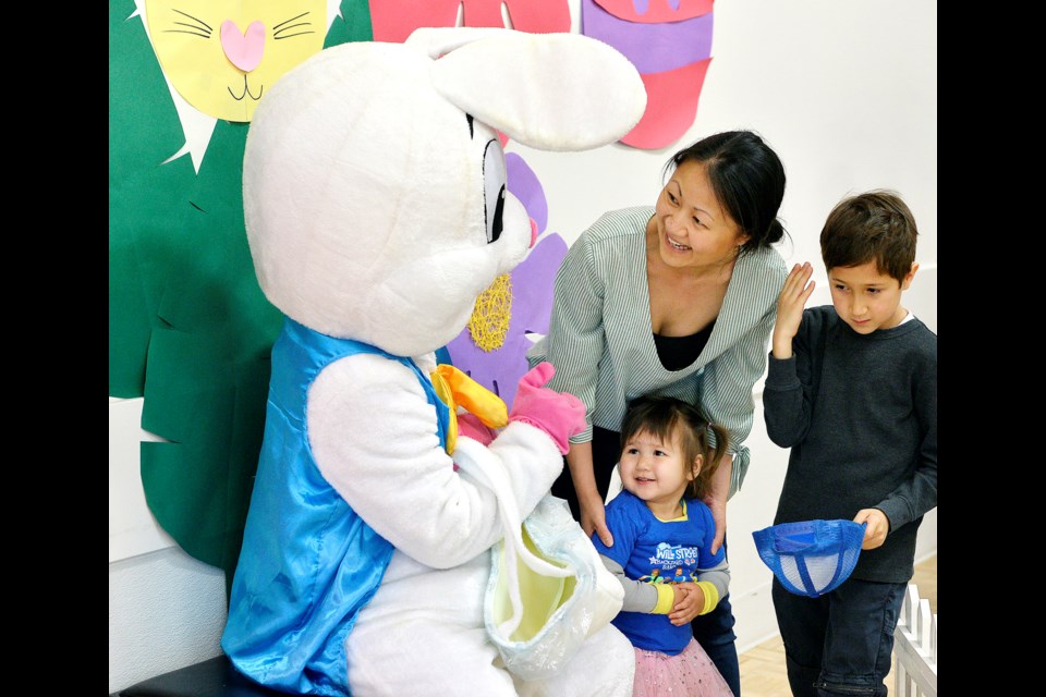 Jacob, 7, and Abigail Smith, 2, meet the Easter Bunny.