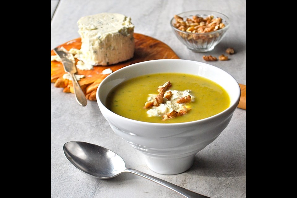 This soup, topped with tangy cheese and walnuts, is made with roasted asparagus.
