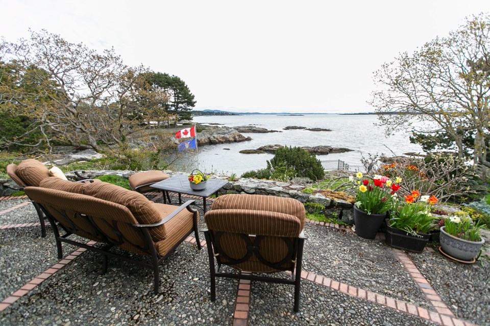 Overlooking a small cove in Oak Bay, the garden terraces on the waterfront home of Dawn and Verne Johnson offer tremendous views.