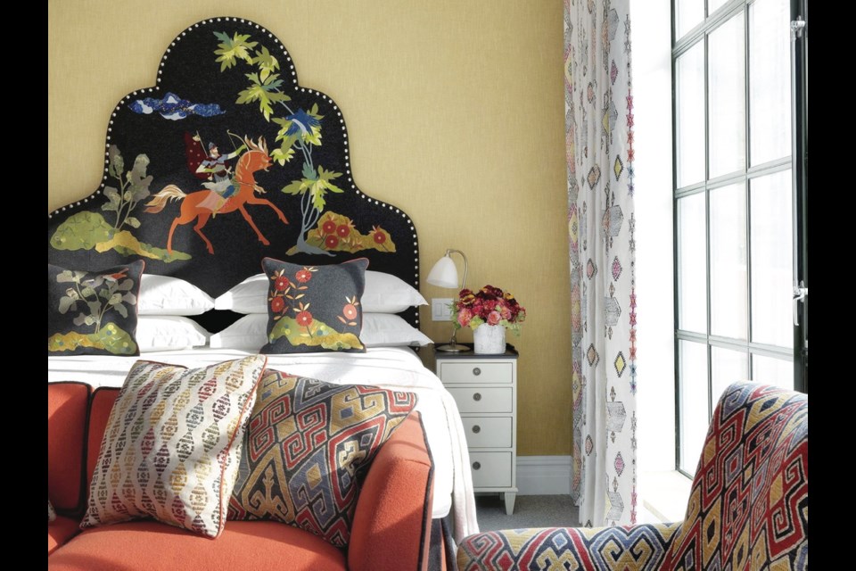 The folk art motif on Kit Kemp's signature headboard leads the way for brilliantly patterned textiles.