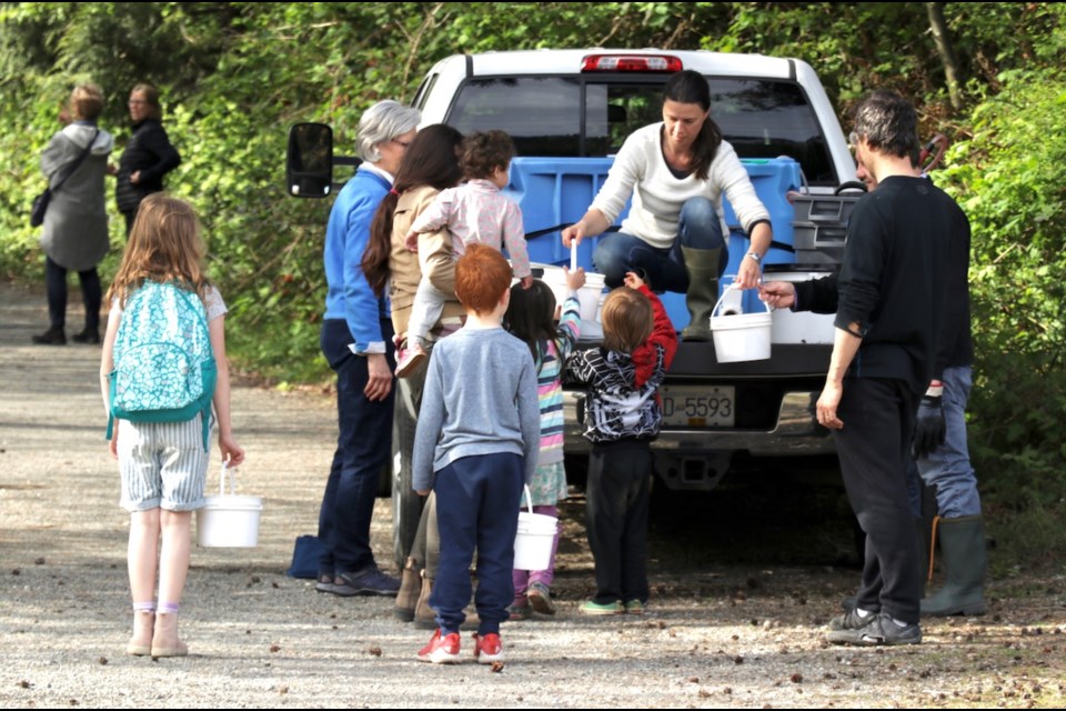 A couple of families showed up to help send off the chum. DFO employees distributed batches of fry in small buckets.